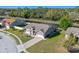 Home with screened-in pool overlooking tranquil waterfront and mature landscaping in the backyard at 8706 Irmastone Way, Orlando, FL 32817