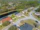 Aerial view of a beautiful home with a screened pool, overlooking a scenic pond in a quiet neighborhood at 8706 Irmastone Way, Orlando, FL 32817