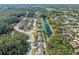 Stunning aerial view of a residential area, featuring beautiful homes, lush greenery, and scenic ponds at 8706 Irmastone Way, Orlando, FL 32817