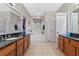 Luxurious bathroom with dual sinks, granite counters, soaking tub and walk-in closet at 8706 Irmastone Way, Orlando, FL 32817