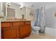 Cozy bathroom featuring a vanity with granite counters, wood cabinets, and a shower-tub combo at 8706 Irmastone Way, Orlando, FL 32817