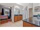 Bathroom view with granite countertop, wood cabinet, glass shower and bedroom with pool view at 8706 Irmastone Way, Orlando, FL 32817