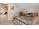 Cozy bedroom features a bed and rocker, with a view to the living area at 8706 Irmastone Way, Orlando, FL 32817
