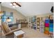 Spacious bonus room features desk, shelving, entertainment center and comfortable chair at 8706 Irmastone Way, Orlando, FL 32817