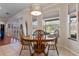 Charming dining area with tile floors, modern light fixture, and views of the pool at 8706 Irmastone Way, Orlando, FL 32817