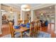 Open concept dining room seamlessly flows into the living area, and features hardwood floors at 8706 Irmastone Way, Orlando, FL 32817