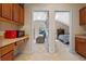 Hallway connecting bedrooms and kitchen with wood cabinets and countertops at 8706 Irmastone Way, Orlando, FL 32817