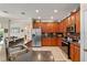 This open kitchen features granite counters, stainless steel appliances, and light tile floors at 8706 Irmastone Way, Orlando, FL 32817