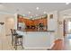Well-equipped kitchen with breakfast bar, granite countertops, stainless steel appliances, and wood cabinetry at 8706 Irmastone Way, Orlando, FL 32817