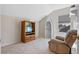 Cozy living room with carpeted floors, neutral walls and a recliner at 8706 Irmastone Way, Orlando, FL 32817