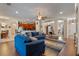 Inviting living room with hardwood floors, a ceiling fan, and an open floorplan to the kitchen and dining areas at 8706 Irmastone Way, Orlando, FL 32817