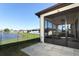 Backyard and covered patio overlooking a pond and green space at 8878 Conway Rd, Polk City, FL 33868