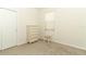Minimalist bedroom with neutral tones, a small window, and a simple chair at 8878 Conway Rd, Polk City, FL 33868