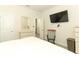 Bedroom with a TV, dresser, and view into an adjacent room at 8878 Conway Rd, Polk City, FL 33868