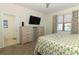Bedroom showcasing a TV, a window overlooking a lake, and a bathroom entrance at 8878 Conway Rd, Polk City, FL 33868