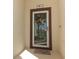 Close-up of the front door featuring a decorative wreath and a welcome mat at 8878 Conway Rd, Polk City, FL 33868