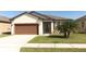 Charming single-story home with a well-maintained lawn and a two-car garage at 8878 Conway Rd, Polk City, FL 33868
