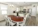 Open-concept kitchen with white cabinetry, stainless steel appliances, and a central island, adjacent to dining area at 8878 Conway Rd, Polk City, FL 33868