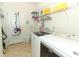 Bright laundry room features stainless steel appliances, tile floors and shelving at 8878 Conway Rd, Polk City, FL 33868