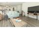 Bright living room with laminate floors and modern decor, open to the kitchen and dining area at 8878 Conway Rd, Polk City, FL 33868