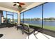 Covered patio featuring ceiling fan, seating and a view of the water at 8878 Conway Rd, Polk City, FL 33868