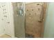 Tiled walk-in shower with seashell decor, multiple shower heads and glass enclosure at 8878 Conway Rd, Polk City, FL 33868