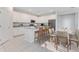 Open kitchen with white cabinets, a granite island, and modern stainless steel appliances at 9560 Starling Loop, Leesburg, FL 34788