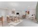 Spacious living room area with tile flooring, comfortable seating, and dining table at 9560 Starling Loop, Leesburg, FL 34788