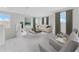 Upstairs living area with ample seating and light from large windows at 9560 Starling Loop, Leesburg, FL 34788