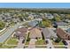 Aerial view of a home with a well-manicured lawn surrounded by neighboring houses and green landscape at 9774 Nonacrest Dr, Orlando, FL 32832