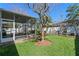 Beautiful backyard with mature trees, a screened lanai, and lush landscaping, creating a private retreat at 9774 Nonacrest Dr, Orlando, FL 32832