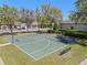 Community basketball court with green surface, white lines, benches, and surrounding greenery at 9774 Nonacrest Dr, Orlando, FL 32832