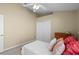 Inviting bedroom featuring a ceiling fan, a comfortable bed, a closet and natural light from the window at 9774 Nonacrest Dr, Orlando, FL 32832