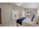 Cozy bedroom featuring a bed, desk and large window that lets in natural light at 9774 Nonacrest Dr, Orlando, FL 32832