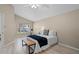 Bedroom with a neutral color palette, tile floors, and a window overlooking the yard at 9774 Nonacrest Dr, Orlando, FL 32832