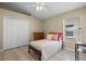 Bright bedroom with vaulted ceilings, wood floors, a comfortable bed and a large closet at 9774 Nonacrest Dr, Orlando, FL 32832