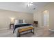 Comfortable bedroom with high ceilings, a bench at the end of the bed, and natural light at 9774 Nonacrest Dr, Orlando, FL 32832