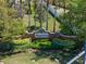 NonaCrest community entrance with brick signage, lush landscaping, and privacy features at 9774 Nonacrest Dr, Orlando, FL 32832
