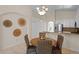Charming dining area features a round table with woven chairs and decorative wall art at 9774 Nonacrest Dr, Orlando, FL 32832