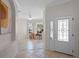 Bright foyer with decorative glass door and view of a living room with wood floors and plenty of natural light at 9774 Nonacrest Dr, Orlando, FL 32832