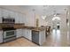 Open kitchen with stainless steel appliances, granite countertops, and a breakfast bar at 9774 Nonacrest Dr, Orlando, FL 32832