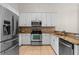 Modern kitchen featuring granite countertops, stainless steel appliances, and white cabinetry at 9774 Nonacrest Dr, Orlando, FL 32832