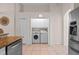 Convenient laundry area with washer, dryer, and cabinets next to the kitchen at 9774 Nonacrest Dr, Orlando, FL 32832