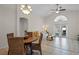 Bright living room with vaulted ceilings, tile floors, and access to the patio at 9774 Nonacrest Dr, Orlando, FL 32832