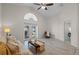 Spacious living room featuring high ceilings, tile floors, and French doors to the yard at 9774 Nonacrest Dr, Orlando, FL 32832