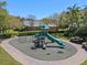 Well-maintained playground with slides and climbing equipment in a green space with trees at 9774 Nonacrest Dr, Orlando, FL 32832