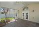 Relaxing screened patio featuring brick pavers and access to the backyard through elegant French doors at 9774 Nonacrest Dr, Orlando, FL 32832