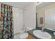 Well-lit bathroom featuring a shower-tub and a vanity with sink at 1207 Winding Cypress Ct, Kissimmee, FL 34746