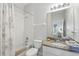 Bright bathroom features a shower-tub combo and granite countertop vanity at 1207 Winding Cypress Ct, Kissimmee, FL 34746