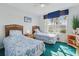 Comfortable bedroom with two twin beds and a bright window view at 1207 Winding Cypress Ct, Kissimmee, FL 34746